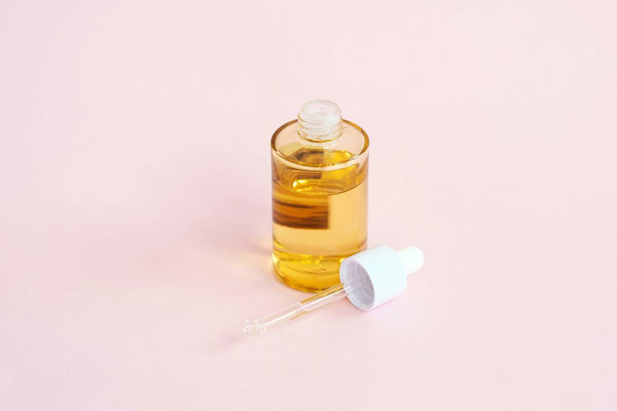 woman applying leave-in hair solution to damp curly hair