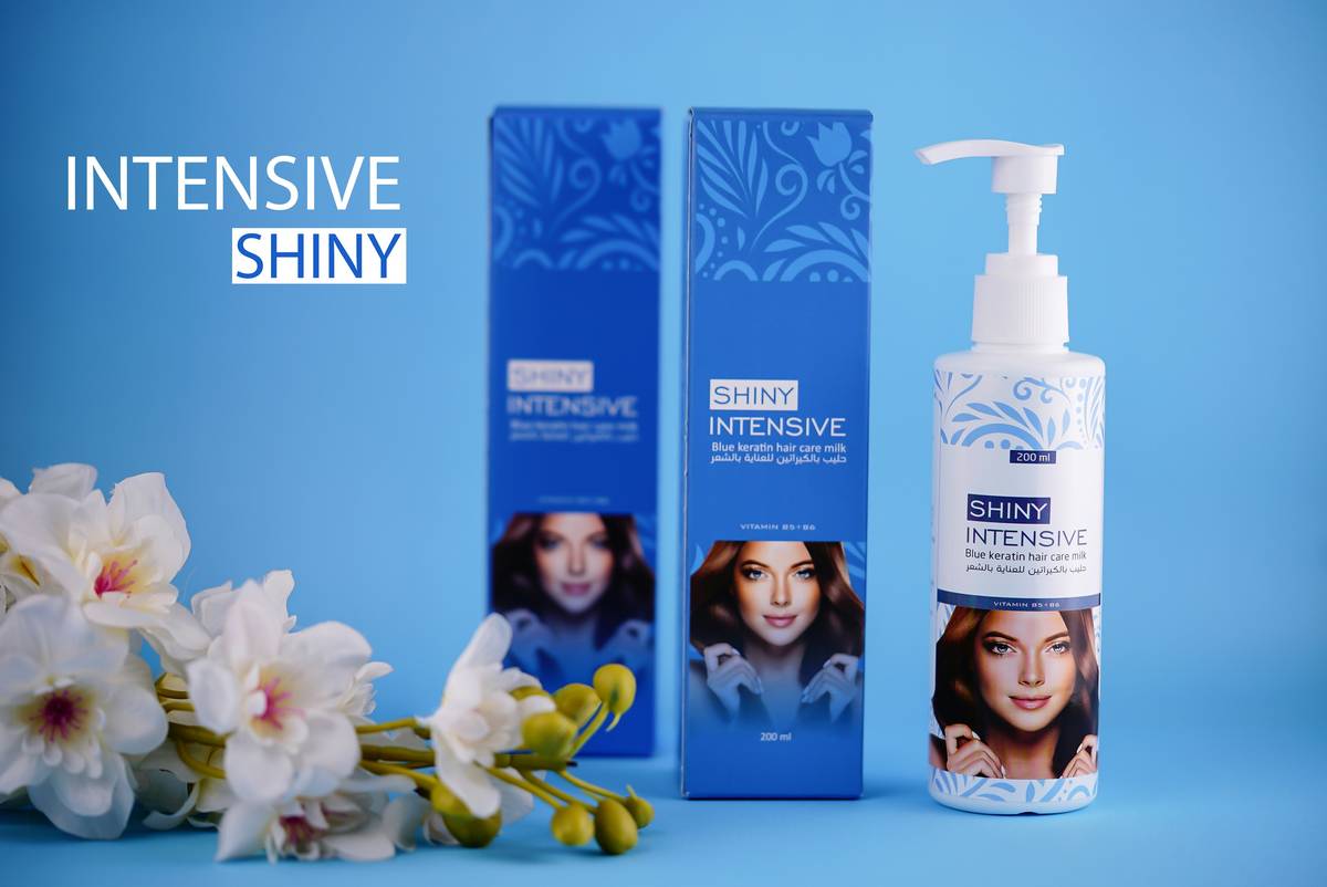 Hand applying leave-in conditioner essence to damp hair strands